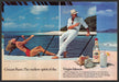 Cruzan Rum 1980s Print Advertisement (2 page) 1982 Couple on the Beach Fetch-the-Paper